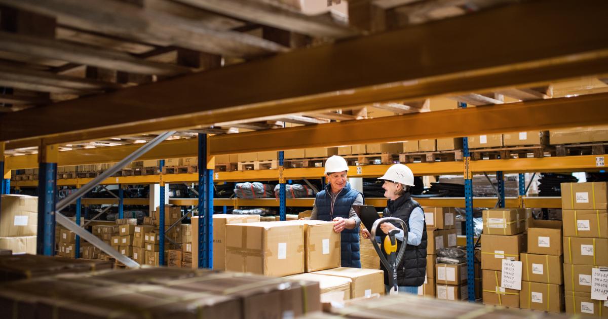 Senior woman and man managers or supervisors working in a warehouse | Is contract logistics the same as thirdparty logistics 3pl