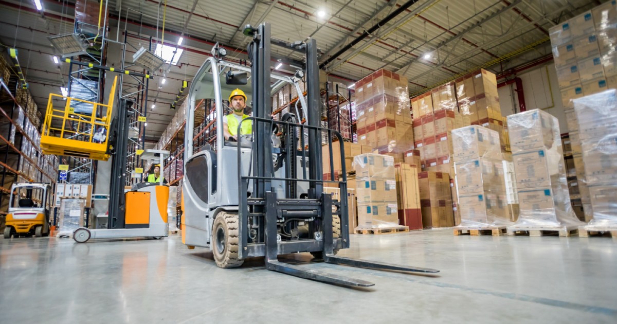 Distribution and Logistics | forklift-operator-during-work-in-large-warehouse