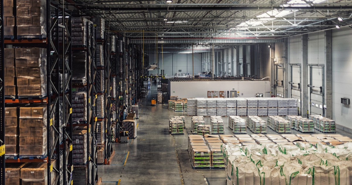 Huge distribution warehouse with high shelves, view from above | Pallet Shipping