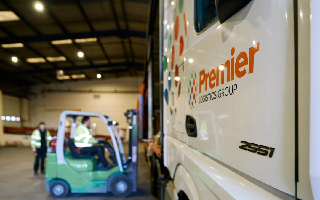 Forklift vehicle loading a Premier Logistics truck